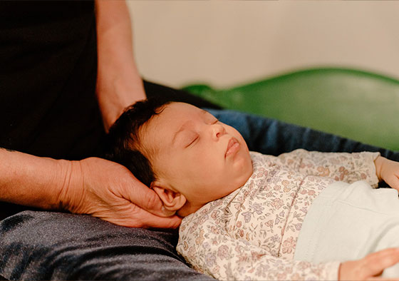 Photo of an infant getting chiropractic adjustment for the back of the head