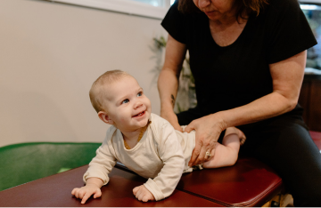 Photo of an infant receiving chiropractic treatment