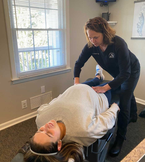 Photo of an pregnant woman receiving chiropractic adjustment