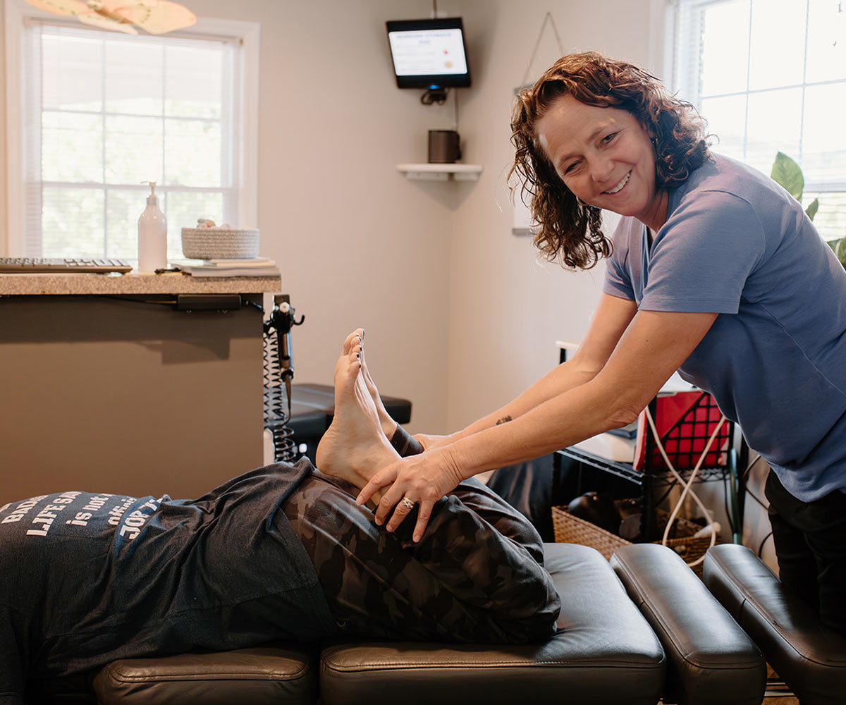 Dr Pam, a chiropractor, adjusting a prenatal, pregnant patient